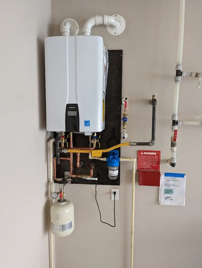 Professional plumber installing copper piping in a Dixon home